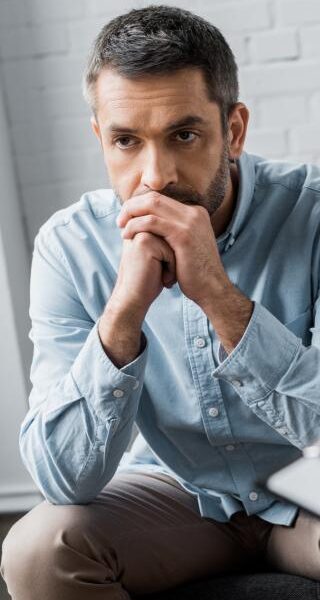 A man thinks during an individual therapy session