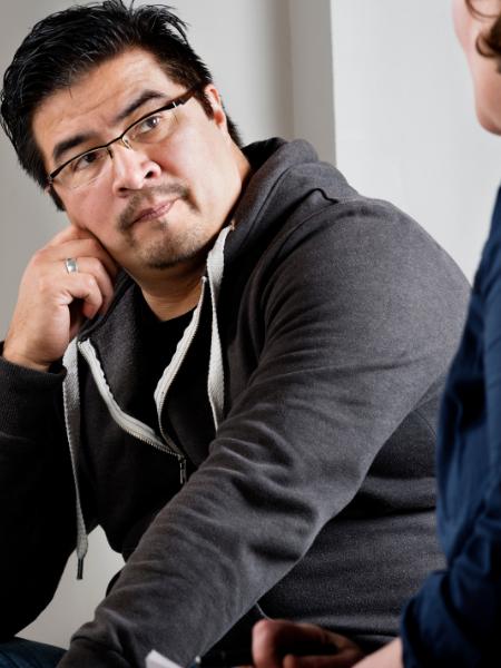 A man listens to his therapist during a mental health counseling session