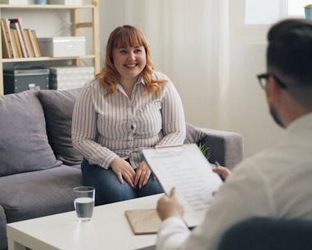 A woman smiles while taking to a mental health therapist